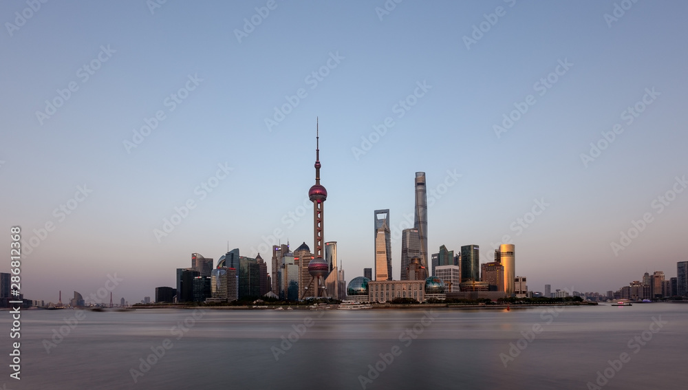 Panorama view of sunset skyline of the bund, Pudong, Shanghai, China with skyscrapers and Huangpu river