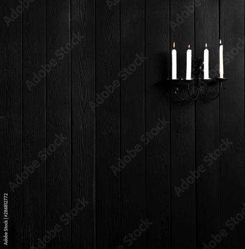 candlestick with candles on a black wall