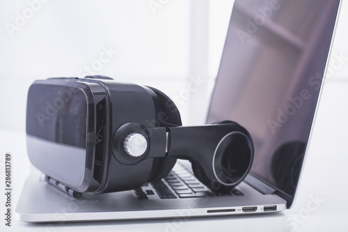 virtual reality glasses lie on a laptop keyboard