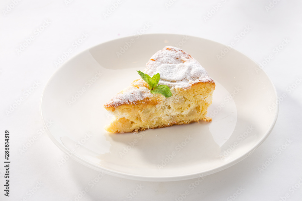 Apple sponge cake on white plate isolated on white background Apple sponge cake on white plate isolated on white background