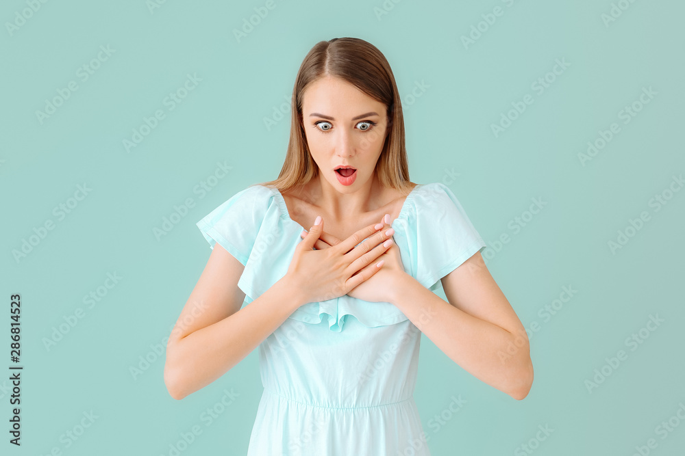 Shocked young woman on color background Shocked young woman on color background