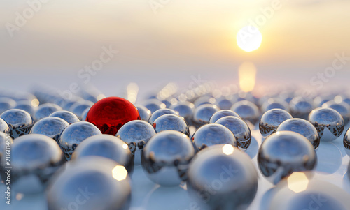 Concept or conceptual collection of balls with a red one standing out on blue background as a metaphor for creativity, leadership and independence. A courage, action and success 3d illustration photo