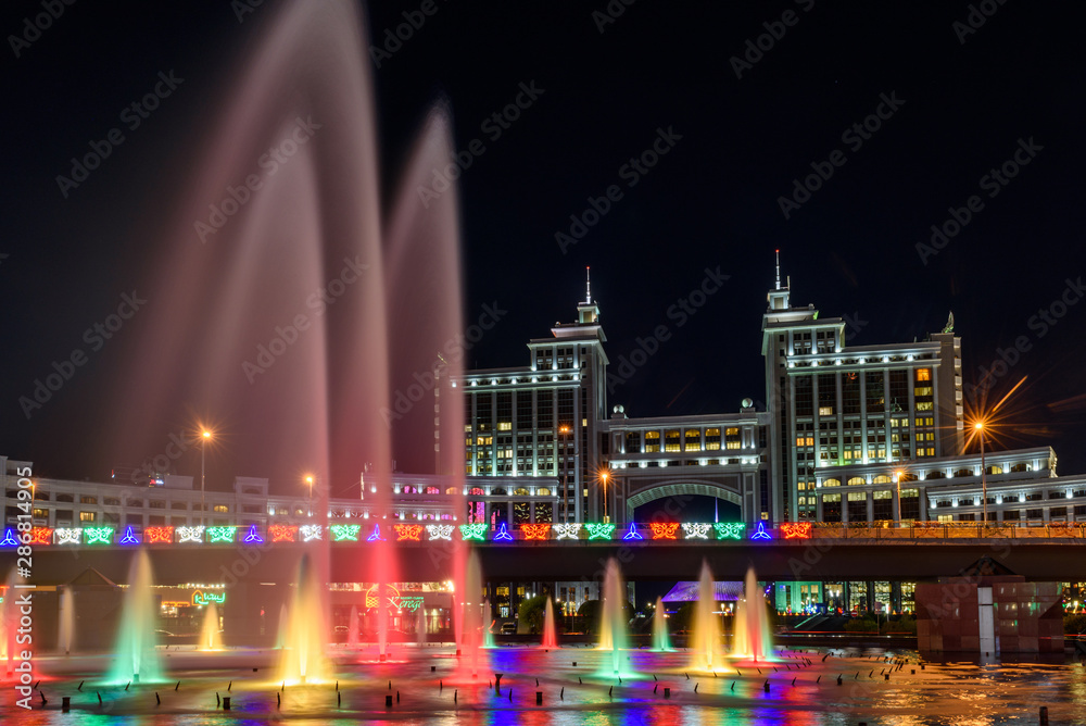 Nur-Sultan, Kazakhstan, August 2019, Fountains with lighting on the background of tall buildings in the center of the capital of Kazakhstan.