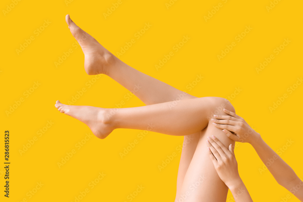 Young woman with slim legs on color background - obrazy, fototapety, plakaty 