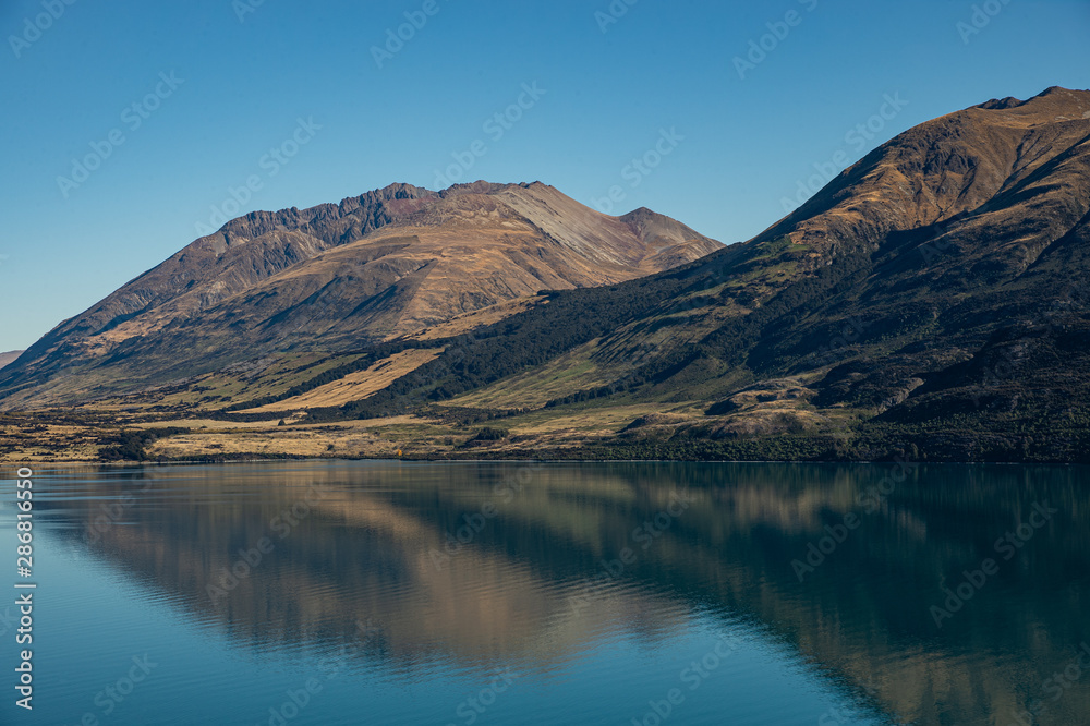 Marvelous scenery invisibly mountain, clear blue sky reflect in turqoise lake, popular view point on the way to Glenorchy, South New Zealand.