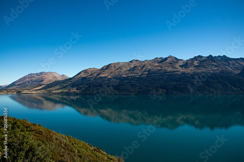 Amazed nature scenic landscape of invisibly mountain, clear blue sky reflection in turquoise lake, popular view point on the way to Glenorchy, South New Zealand.