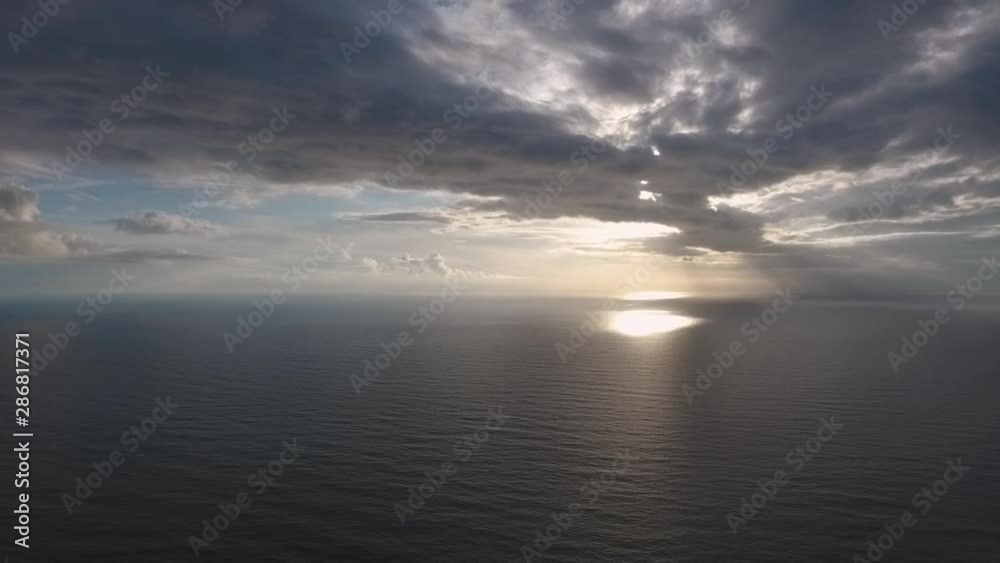 Aerial view of Portuguese Atlantic ocean, with sun reflecting on the ocean and pearcing through beautiful cloud formations Aerial view of Portuguese Atlantic ocean, with sun reflecting on the ocean and pearcing through beautiful cloud formations