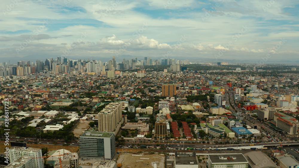 Obraz premium Manila city with skyscrapers, modern buildings and Makati business center, aerial drone. Travel vacation concept.