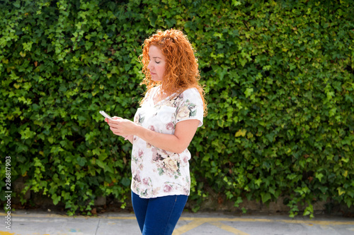 woman using cell phone to send an email