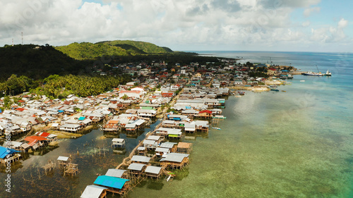 Fishing Village of stilt houses built over the sea, top view. Dapa, Siargao, Philippines. © Alex Traveler