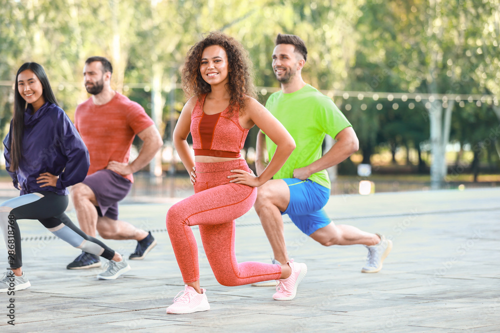 Group of young sporty people training together outdoors Group of young sporty people training together outdoors