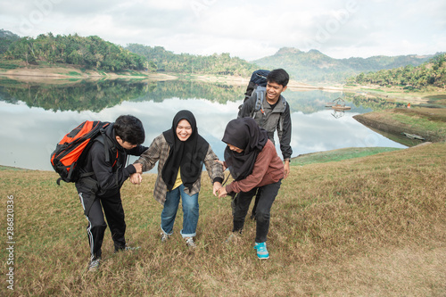 Woman hijab getting help when hike from their friends