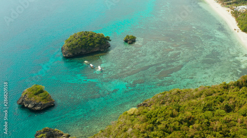 Fototapeta Naklejka Na Ścianę i Meble -  Tropical sandy beach near the blue lagoon and corall reef, aerial view Boracay, Philippines. Ilig Iligan Beach. Summer and travel vacation concept.