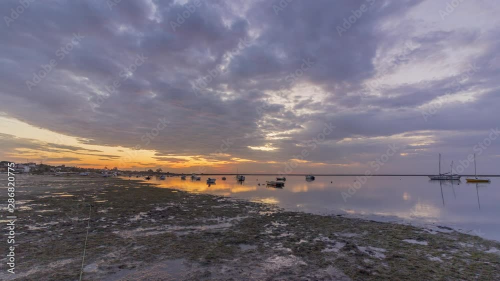 Sunrise timelapse cloudy seascape, in Ria Formosa wetlands natural park, shot in Cavacos beach. Algarve. Portugal. Sunrise timelapse cloudy seascape, in Ria Formosa wetlands natural park, shot in Cavacos beach. Algarve. Portugal.