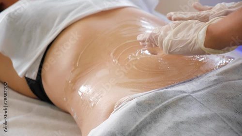 Hardware cosmetology. Body care. Spa treatment. Ultrasound cavitation body contouring treatment. Woman getting anti-cellulite and anti-fat therapy in beauty salon.