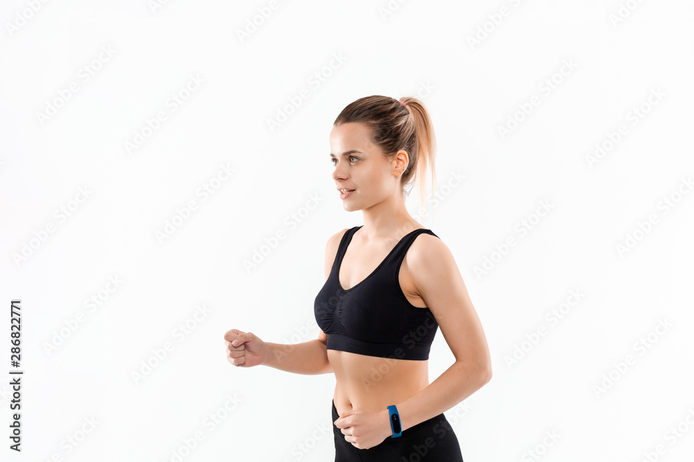 Young sporty blond woman in a black sportswear running isolated over white background. Young sporty blond woman in a black sportswear running isolated over white background.