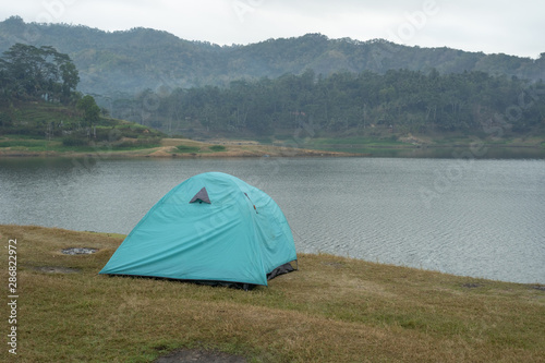 Camping tent in the nature side a lake