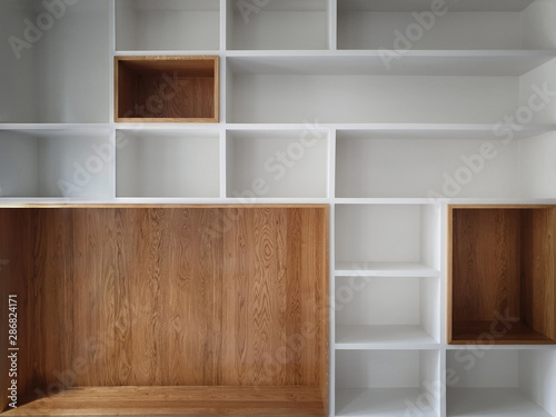 Empty closet shelves background. Modern wooden wardrobe boxes, beautiful white and brown interior design combination, abstract shape and patterns. photo
