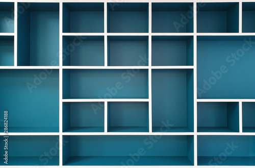 Empty closet shelves background. Modern wooden wardrobe boxes, beautiful blue and white frame interior design combination, abstract shape and patterns.