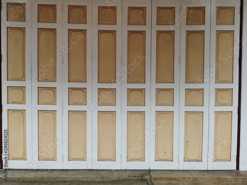 Antique wooden doors, white and cream colors and exterior architectural exterior