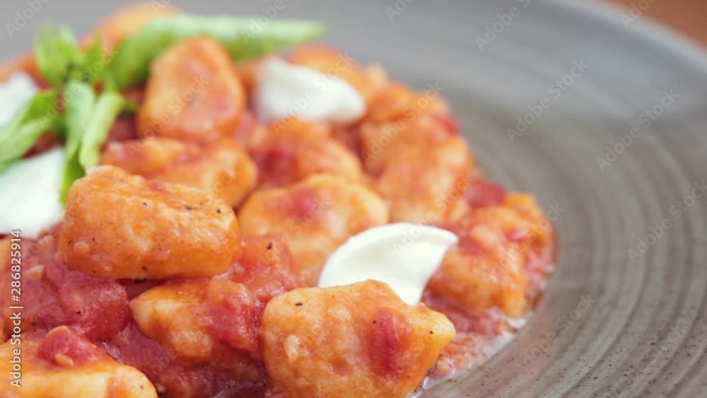 A close up shot of an amazing fresh tomato based gnocchi with red wine. A close up shot of an amazing fresh tomato based gnocchi with red wine.