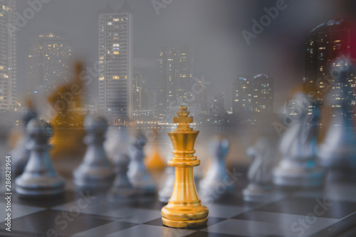 Double exposure image of chess and cityscape. Leadership of leaders will lead the team to success in business together with business of corporation.