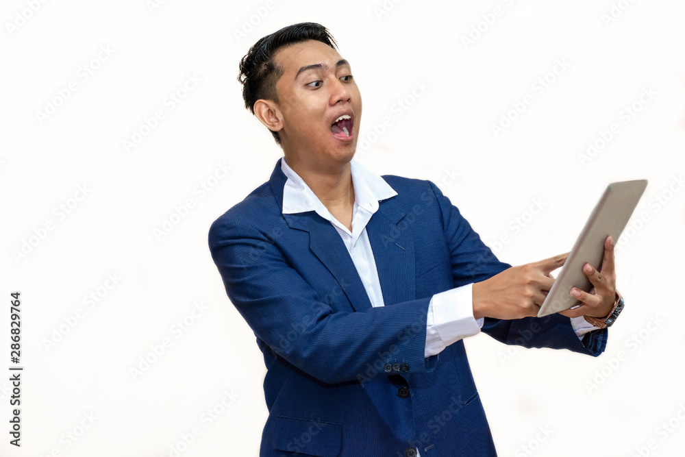 Portrait young asian businessman surprised happy looking tablet computer Portrait young asian businessman surprised happy looking tablet computer