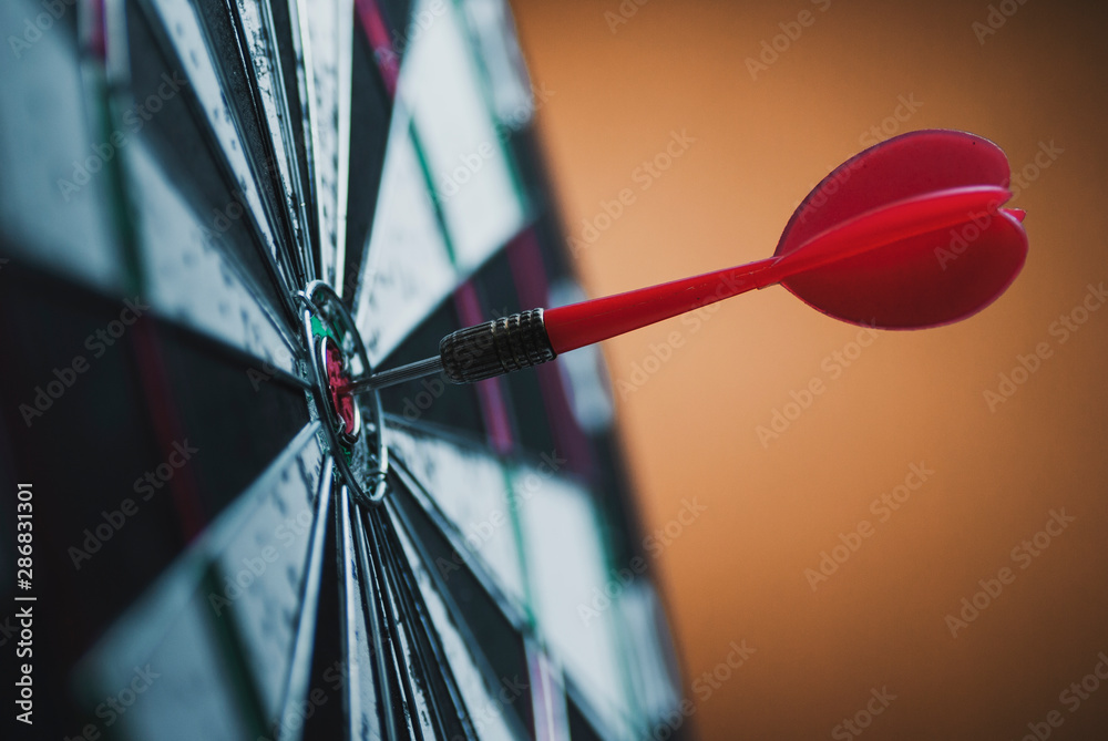 Successful bulls eye centre dart on a target