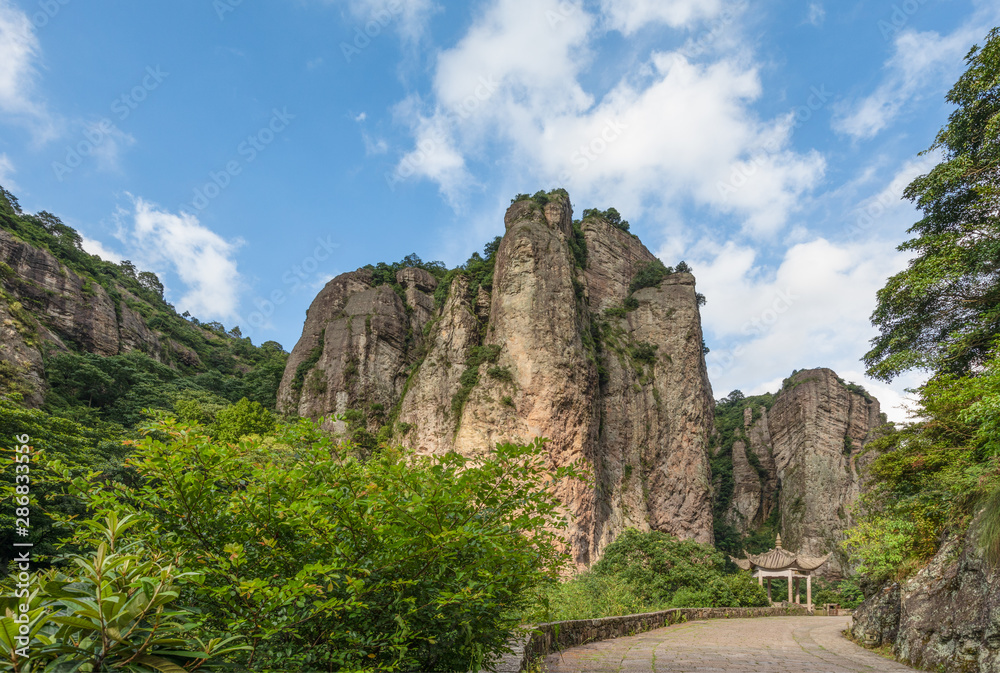 Mountains at Lingfeng Area of Mount Yandang with a traditional Chinese pavilion and road in Yueqing, Zhejiang, China.