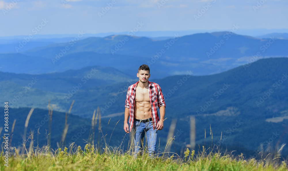 Strong hiker muscular torso. Athlete muscular guy relax mountains. Hiking concept. Muscular tourist walk mountain hill. Power of nature. Man unbuttoned shirt stand top mountain landscape background Strong hiker muscular torso. Athlete muscular guy relax mountains. Hiking concept. Muscular tourist walk mountain hill. Power of nature. Man unbuttoned shirt stand top mountain landscape background