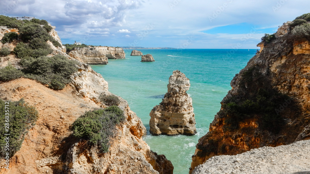 Panoramic view of the Algarve ocean cliffs, Portugal, with cloudy dramatic sky