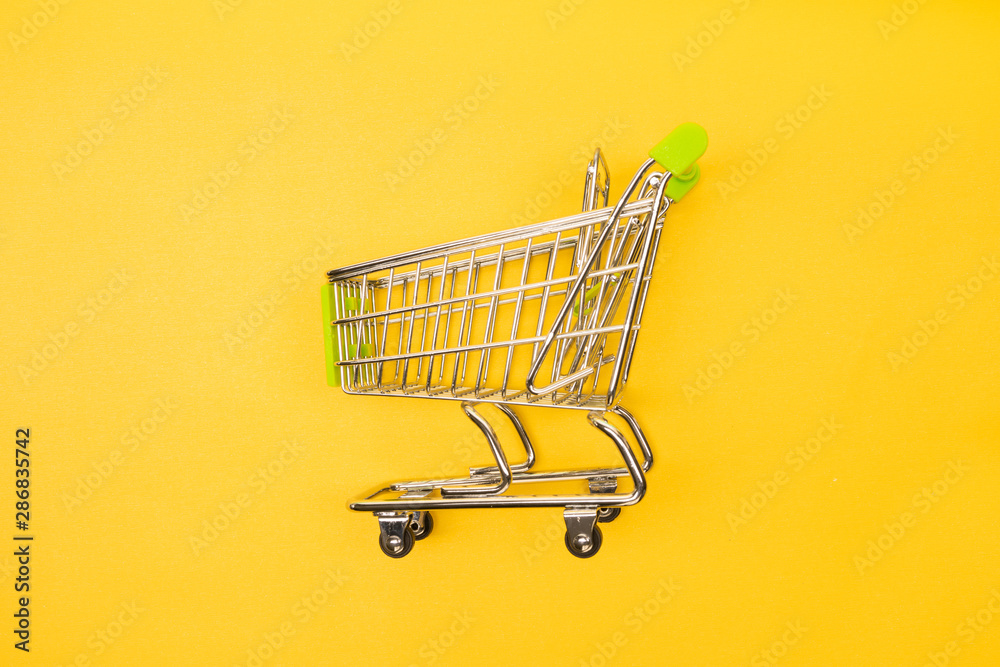 supermarket trolley on yellow background supermarket trolley on yellow background