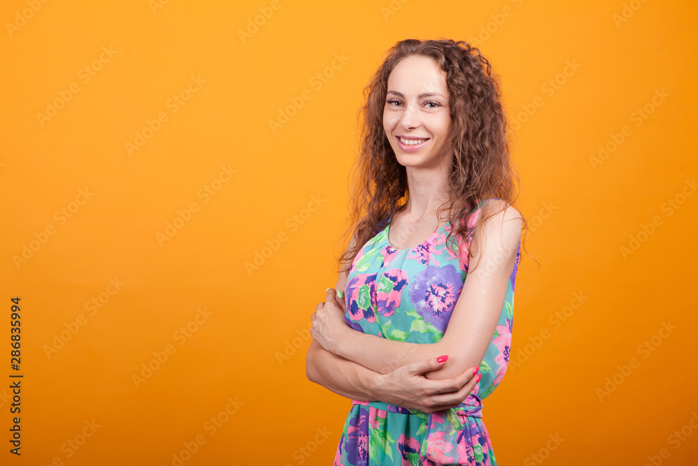 Side view studio shot of cheerful woman with hands crossed Side view studio shot of cheerful woman with hands crossed