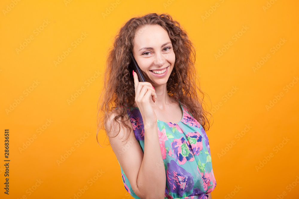 Beautiful young woman in summer dress talking on the phone Beautiful young woman in summer dress talking on the phone