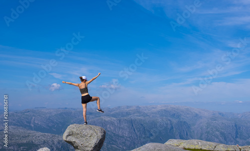 girl on the top of the mountain, celebrating success by reaching the summit