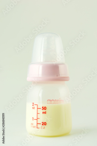 Baby bottle milk small size 2 oz or 50 ml on white.