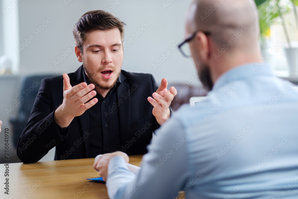 Confident young man attending job interview Confident young man attending job interview