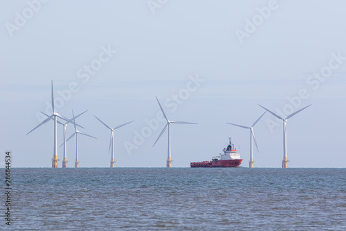 Offshore wind farm turbines with maintenance supply vessel ship