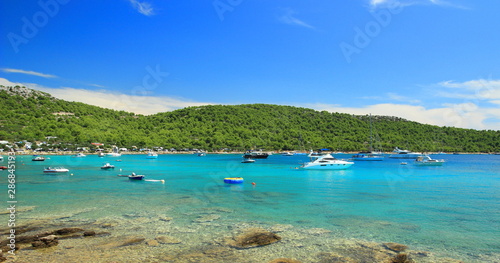 Clear blue sea and touristic boats in bay Kosirina on Island Murter in Croatia 