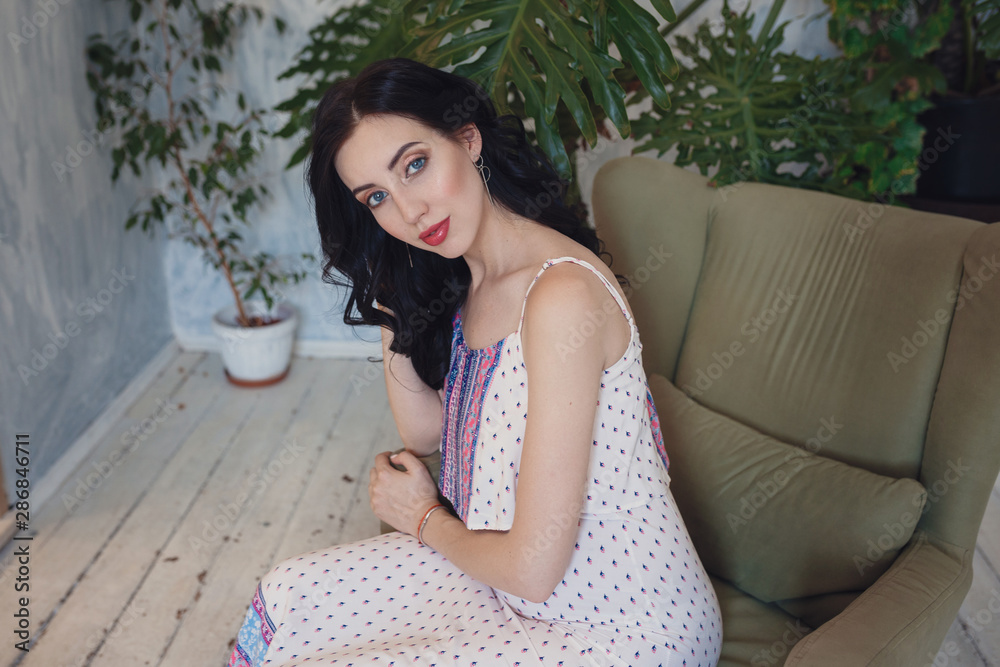 Pregnant european woman in white dress in flat Pregnant european woman in white dress in flat