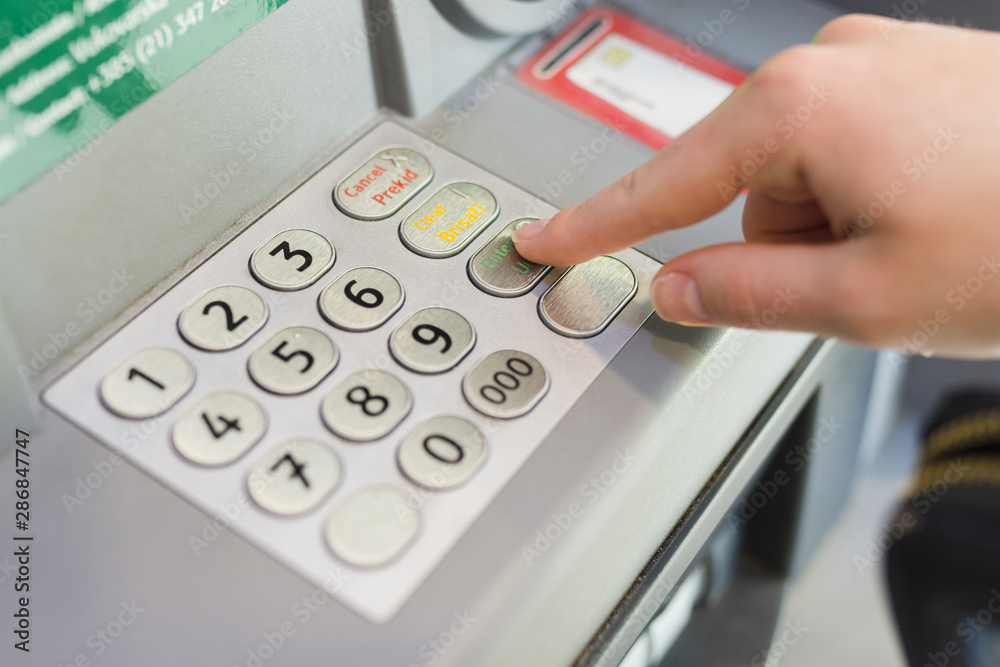 Person withdrawing some money from the atm Person withdrawing some money from the atm