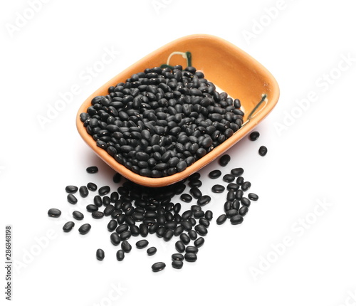 Black beans in clay bowl, pot isolated on white background