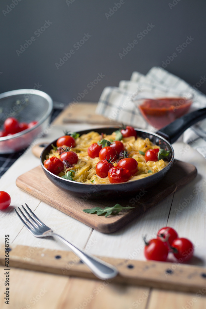 spaghetti with cherry tomatoes in a pan