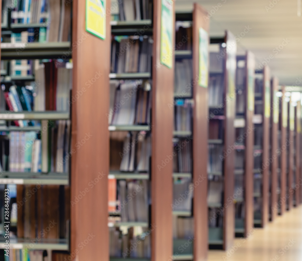 Picture of blur bookshelf as background in library with copy space. Photo concept of education, knowledge, traditional learning, and literature.