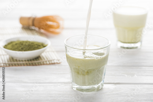green matcha tea with milk on white table