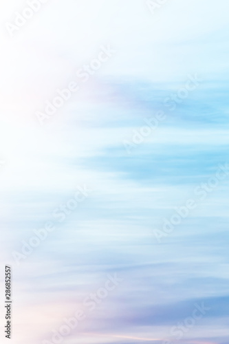 Vertical ratio size of sunset background. sky with soft and blur pastel colored clouds. gradient cloud on the beach resort. nature. sunrise.  peaceful morning. Instagram toned style