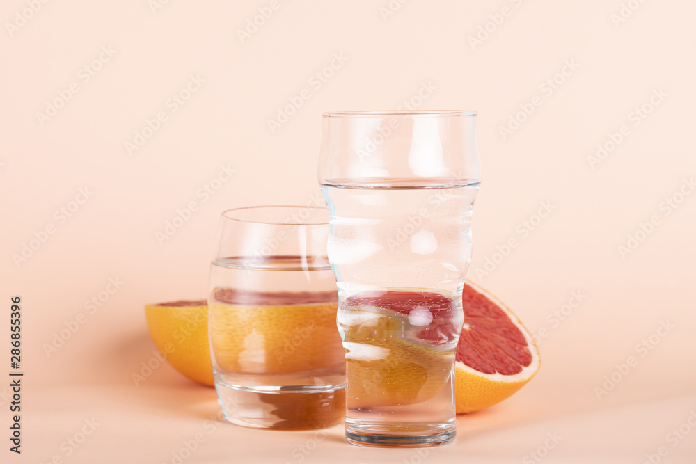 Arrangement with red orange and glasses of water Arrangement with red orange and glasses of water