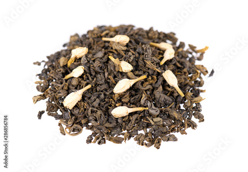Green tea with jasmine, isolated on white background. Aromatic green dry tea, close up.