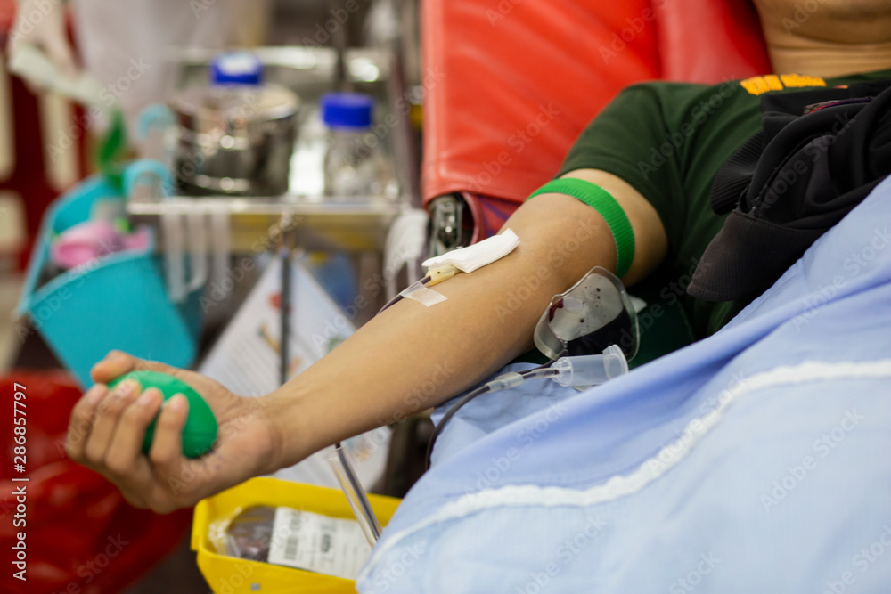 Blood donor at donation with a bouncy ball holding in hand, image for Thailand Aug 2019. Blood donor at donation with a bouncy ball holding in hand, image for Thailand Aug 2019.