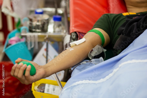 Blood donor at donation with a bouncy ball holding in hand, image for Thailand Aug 2019.